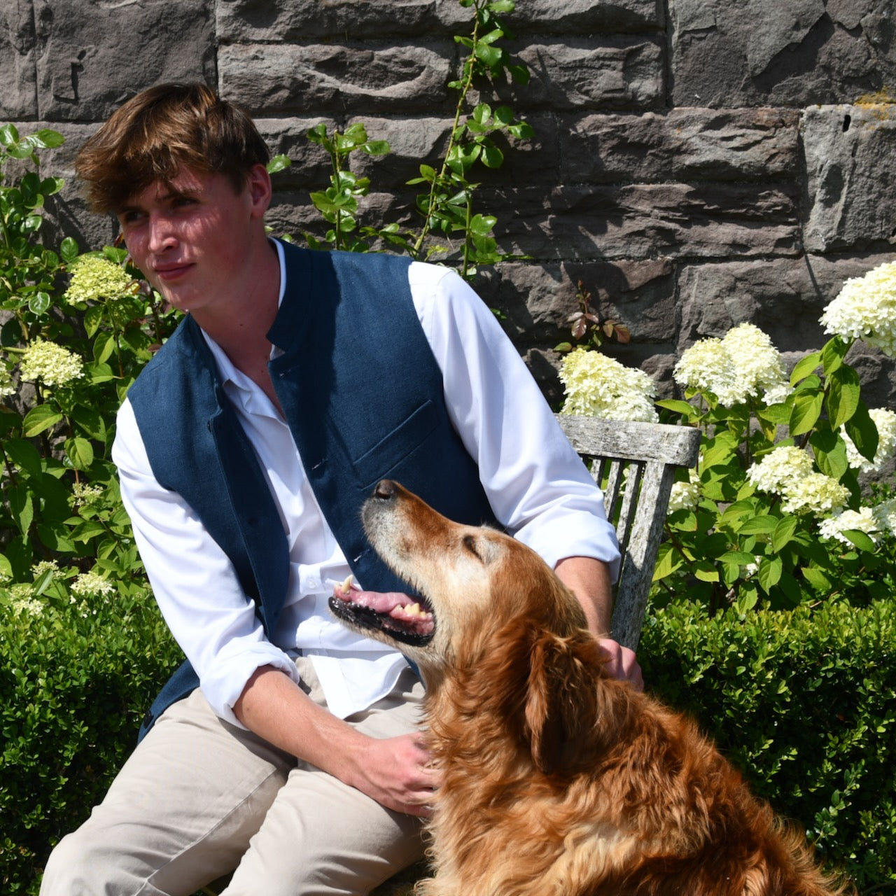 Navy Linen Loose Cut Waistcoat. A bespoke Pure Irish Linen waistcoat, handmade in London. Lined in pure cotton ticking with a Nehru collar. Worn open over a blue shirt. With dog.