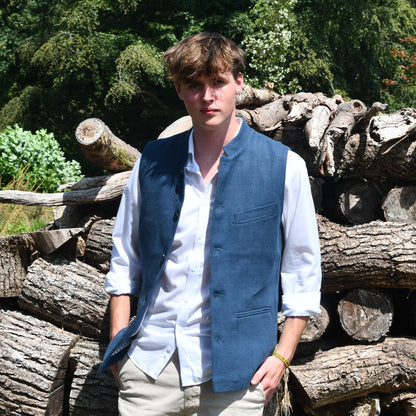 Navy Linen Loose Cut Waistcoat. A bespoke Pure Irish Linen waistcoat, handmade in London. Lined in pure cotton ticking with a Nehru collar. Worn over a blue shirt, Full length view.