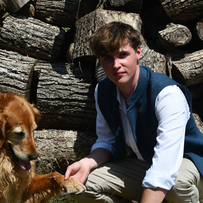 Navy Linen Loose Cut Gilet. A bespoke Pure Irish Linen waistcoat, handmade in London. Lined in pure cotton ticking with a Nehru collar. Worn open over a blue shirt, Full length view.