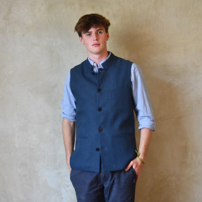 Navy Linen Fitted Cut Waistcoat. A bespoke Pure Irish Linen waistcoat, handmade in London. Lined in pure cotton ticking with a Nehru collar. Worn over a blue shirt, Full length view.