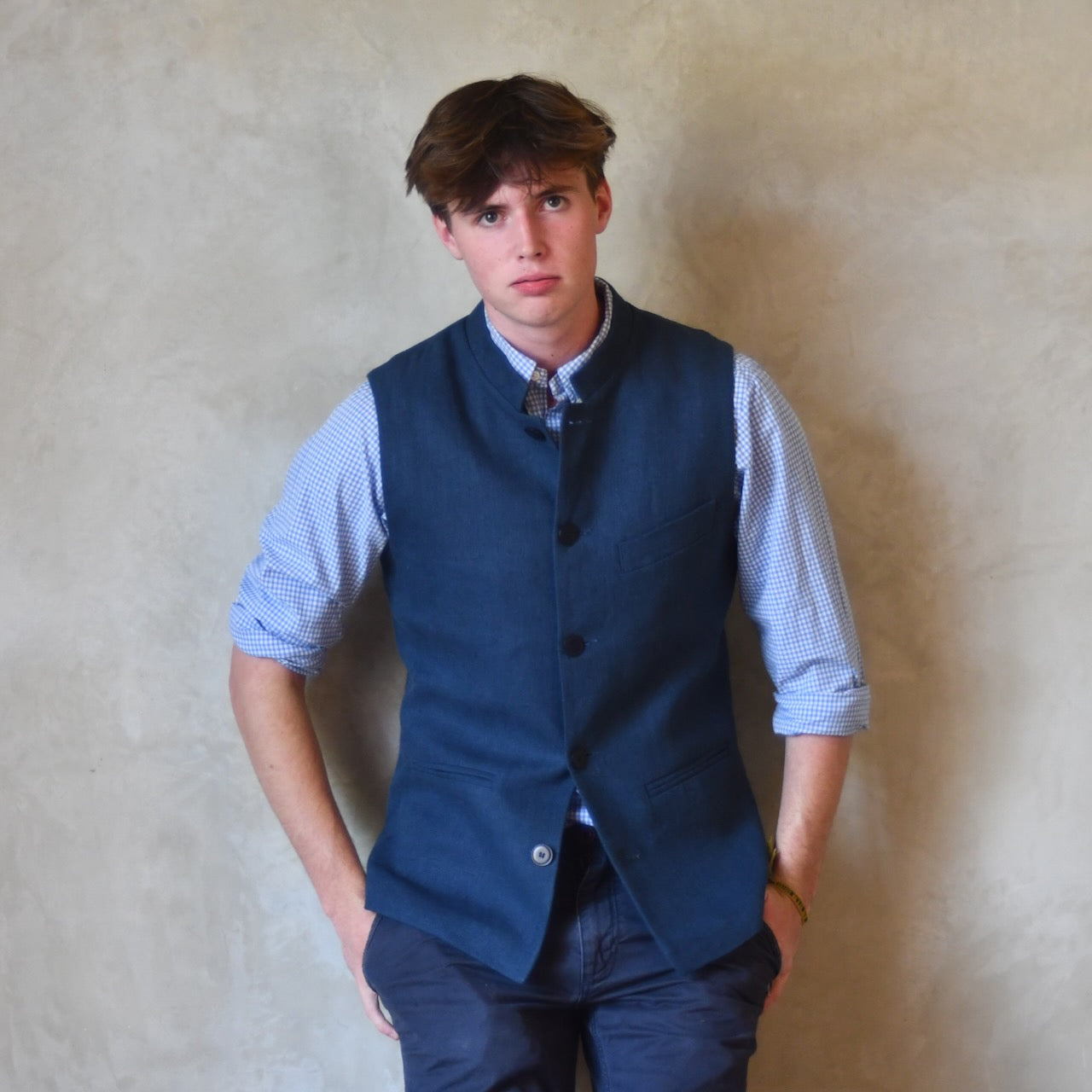 Navy Linen Slim Cut Gilet. A bespoke Pure Irish Linen waistcoat, handmade in London. Lined in pure cotton ticking with a Nehru collar. Worn over a blue shirt.