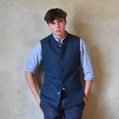 Navy Linen Slim Cut Gilet. A bespoke Pure Irish Linen waistcoat, handmade in London. Lined in pure cotton ticking with a Nehru collar. Worn over a blue shirt.