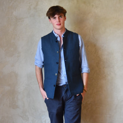 Navy Linen Slim Cut Gilet. A bespoke Pure Irish Linen waistcoat, handmade in London. Lined in pure cotton ticking with a Nehru collar. Worn over a blue shirt, Full length view.