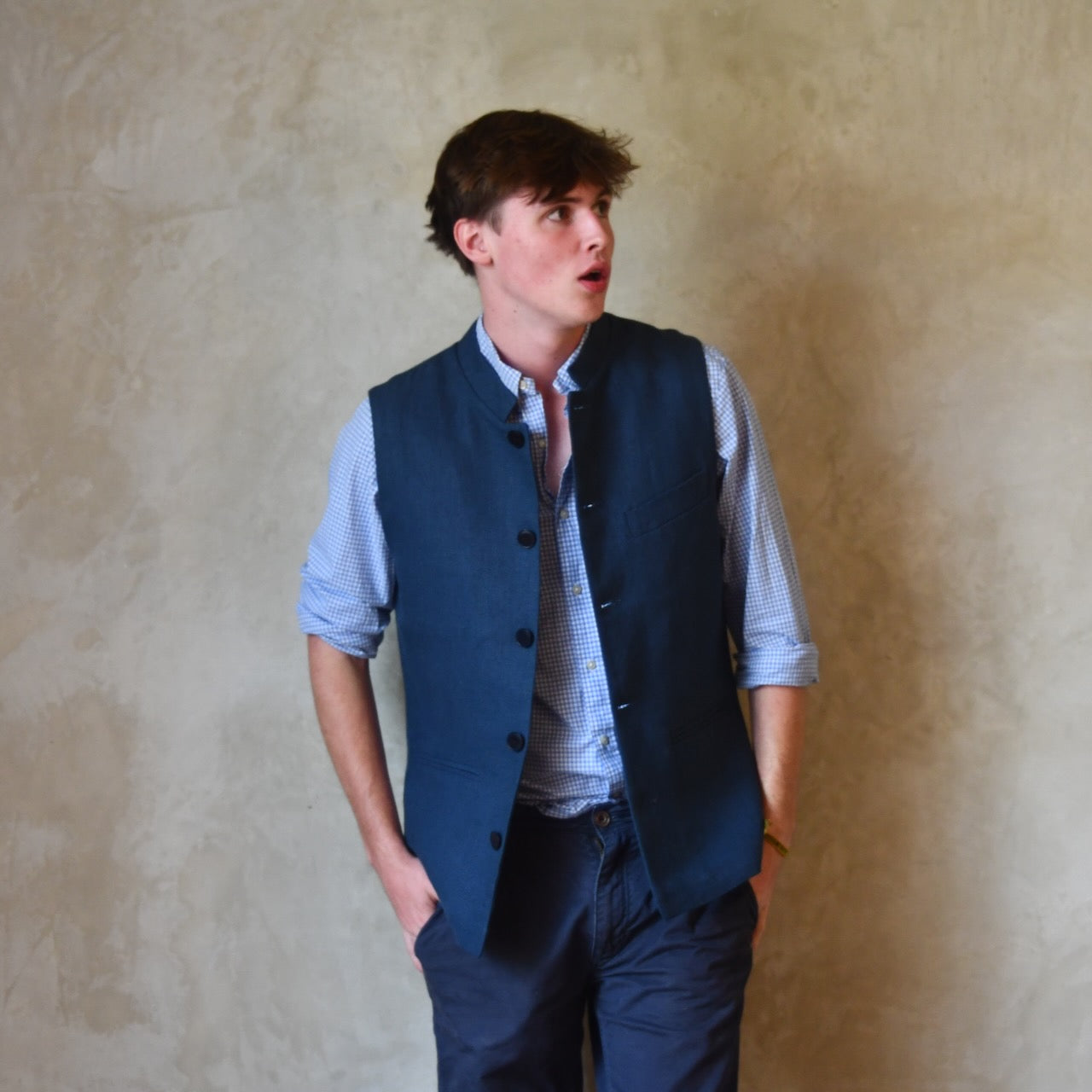 Navy Linen Slim Cut Gilet. A bespoke Pure Irish Linen waistcoat, handmade in London. Lined in pure cotton ticking with a Nehru collar. Worn open over a blue shirt.