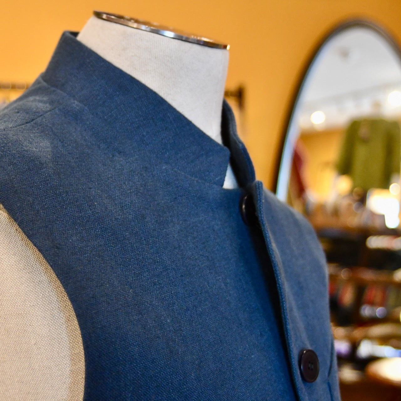Loose cut Nehru Style Gilet in Deep Navy Linen. This handmade gilet is made from a relaxed mid weight Irish linen. With e Nehru collar detail, three external pockets and a five-buttoned front it is smart enough for work - and yet perfect for the weekend. Side Front Shot.