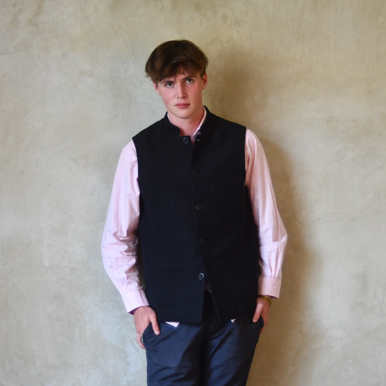 Nehru style gilet in navy moleskin. A bespoke loose fit gilet in a pure cotton navy moleskin fabric handmade for you in London. Shown buttoned up over pink shirt.