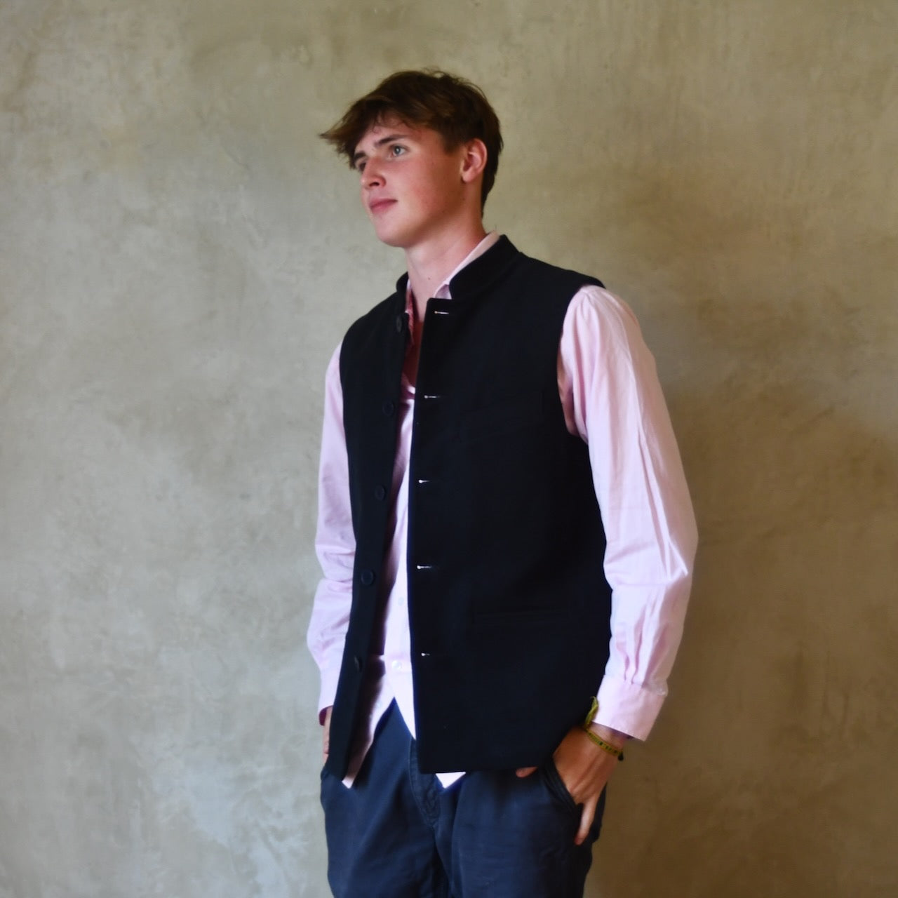 Nehru style gilet in navy moleskin. A bespoke loose fit gilet in a pure cotton navy moleskin fabric handmade for you in London. Shown worn open over pink shirt.