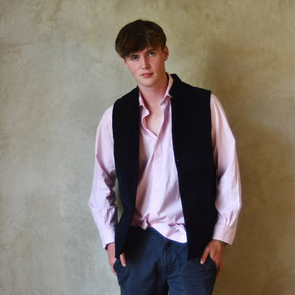 Nehru style gilet in navy moleskin. A bespoke loose fit gilet in a pure cotton navy moleskin fabric handmade for you in London. Shown worn open over pink shirt.