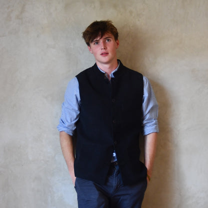 Nehru style gilet in navy moleskin. A bespoke slim-fit gilet in a pure cotton navy moleskin fabric handmade for you in London. Shown worn closed over blue shirt.