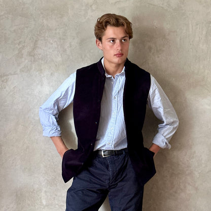 Slim Cut Nehru Style Gilet in Navy Velvet. This pure cotton velvet waistcoat is lined in pure cotton striped ticking. Handmade in London the gilet has three outer and two inner pockets. a Nehru collar and Blue Corozo Buttons. Perfect for a swell night out.