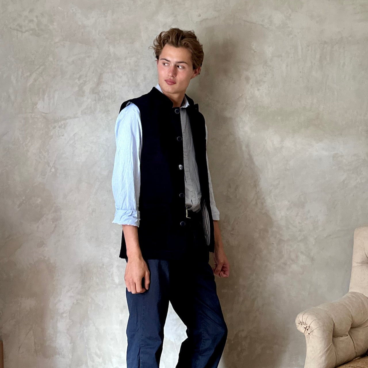 Slim Cut Nehru Style Gilet in Navy Velvet. This pure cotton velvet waistcoat is lined in pure cotton striped ticking. Handmade in London the gilet has three outer and two inner pockets. a Nehru collar and Blue Corozo Buttons. Perfect for a swell night out.