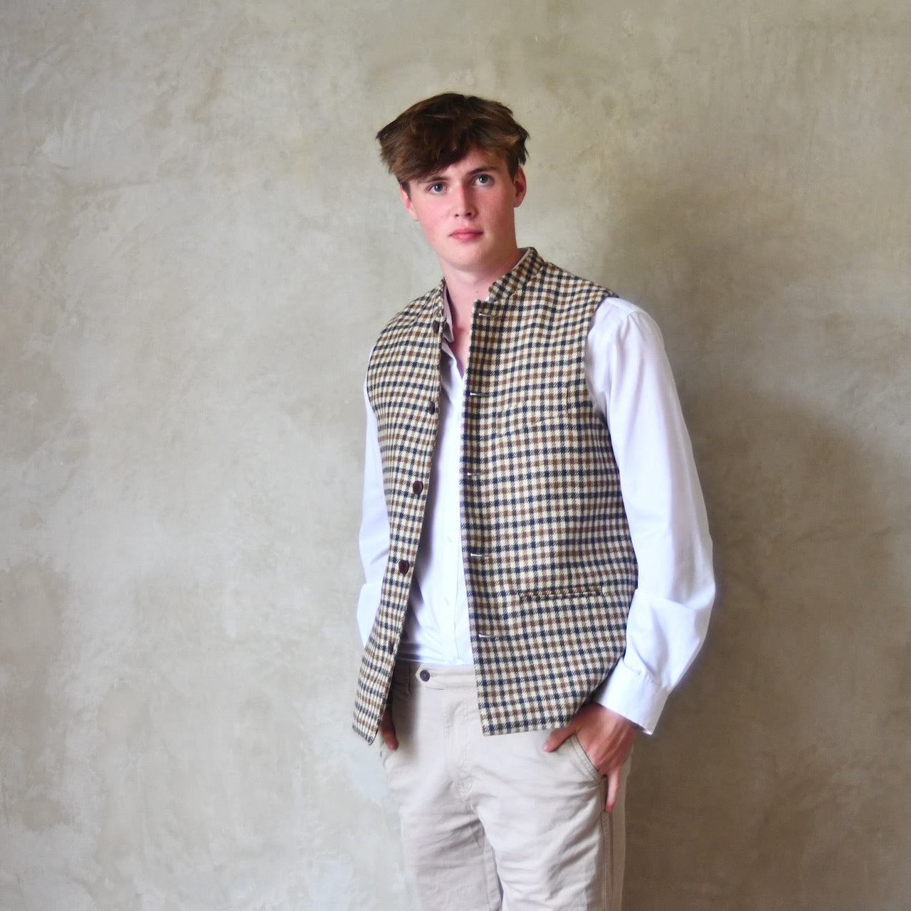 Loose Fit Nehru-style gilet in pure wool checked tweed. This gunclub check tweed waistcoat has a softer than usual feel, being made from fabric woven in Somerset. Handmade in London these waistcoats can be ordered in size 26 to 54 and bespoke sizes.