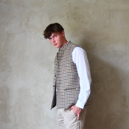 Loose Fit Nehru-style gilet in pure wool checked tweed. This gunclub check tweed waistcoat has a softer than usual feel, being made from fabric woven in Somerset. Handmade in London these waistcoats can be ordered in size 26 to 54 and bespoke sizes.