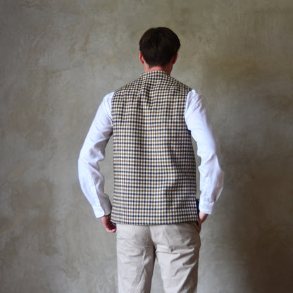 Rear View of Loose Fit Nehru-style gilet in pure wool checked tweed. This gunclub check tweed waistcoat has a softer than usual feel, being made from fabric woven in Somerset. Handmade in London these waistcoats can be ordered in size 26 to 54 and bespoke sizes.