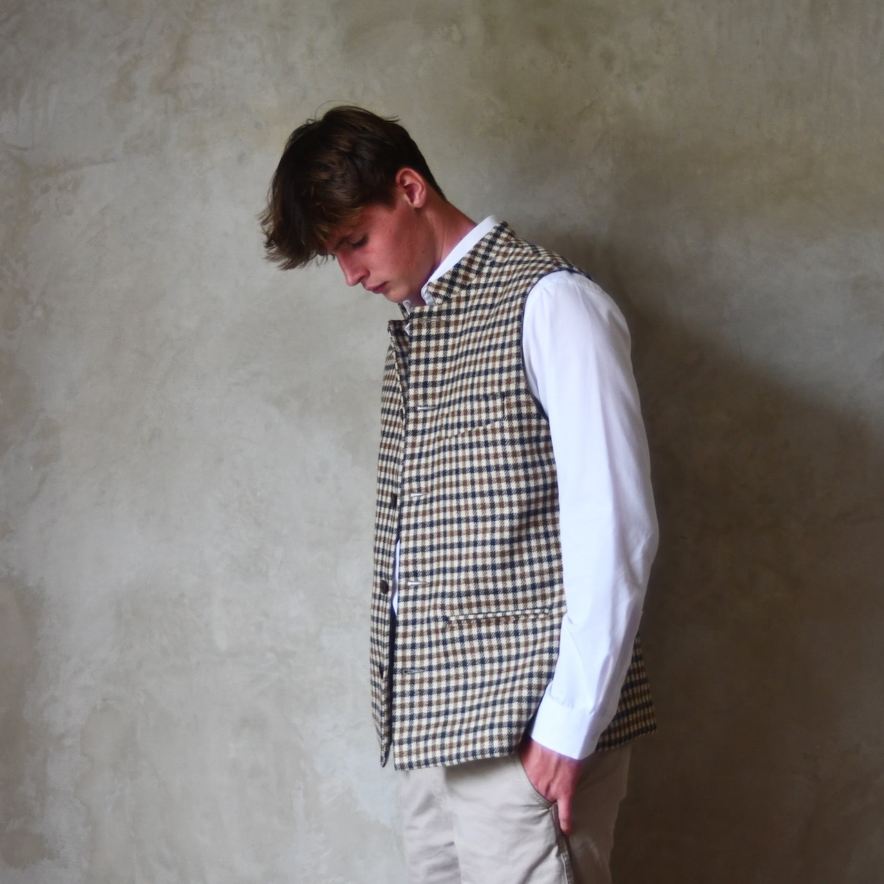 Fitted Nehru-style gilet in pure wool tweed. This gunclub check tweed waistcoat has a softer than usual feel, being made from fabric woven in Somerset. Handmade in London these waistcoats can be ordered in size 26 to 54 and bespoke sizes.