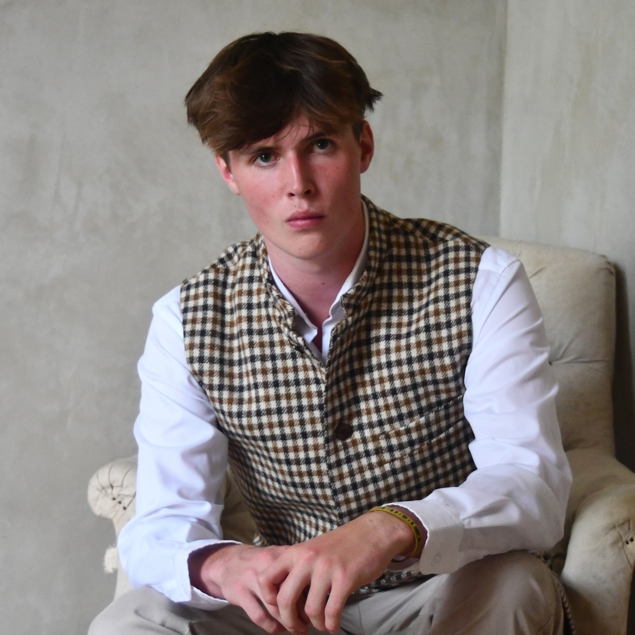 Fitted Nehru-style gilet in pure wool tweed. This gunclub check tweed waistcoat has a softer than usual feel, being made from fabric woven in Somerset. Handmade in London these waistcoats can be ordered in size 26 to 54 and bespoke sizes.