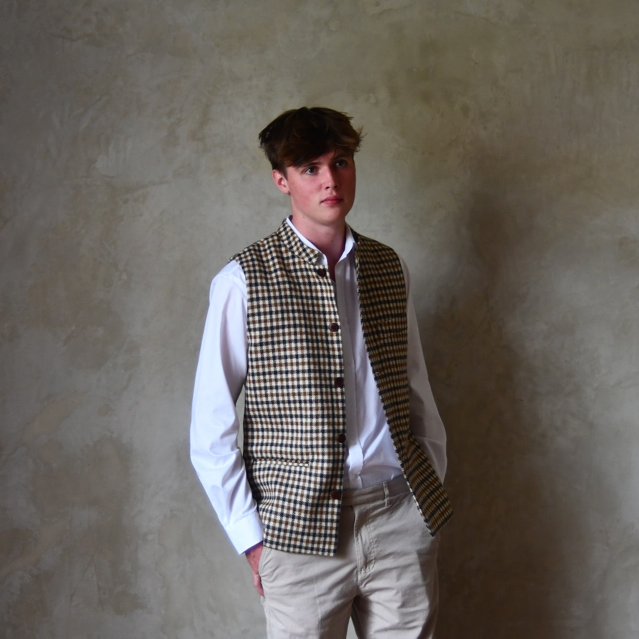 Unbuttoned full length view of Fitted Nehru-style gilet in pure wool tweed. This gunclub check tweed waistcoat has a softer than usual feel, being made from fabric woven in Somerset. Handmade in London these waistcoats can be ordered in size 26 to 54 and bespoke sizes.
