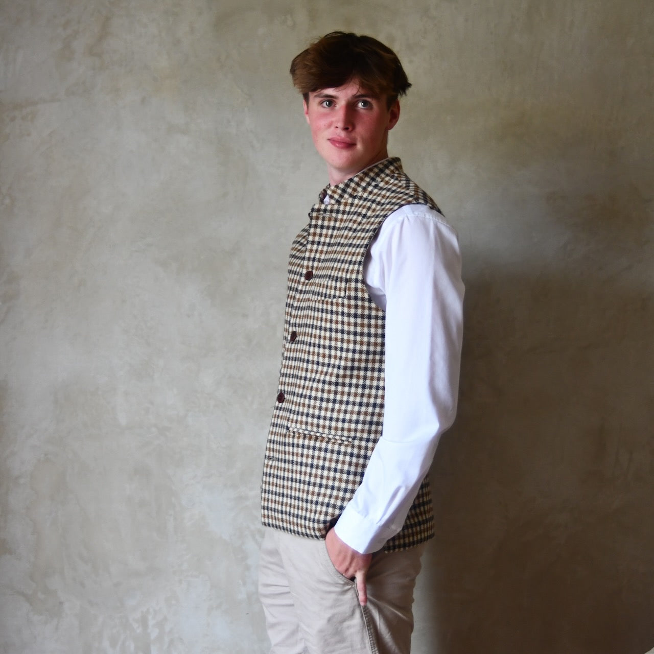 Fitted Nehru-style gilet in pure wool tweed. This gunclub check tweed waistcoat has a softer than usual feel, being made from fabric woven in Somerset. Handmade in London these waistcoats can be ordered in size 26 to 54 and bespoke sizes.