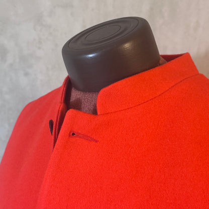 Fabric close up on a bright orange Nehru Style Gilet in pure merino wool flannel. Woven in Yorkshire this merino melton has a wonderful handle and a lovely warm weight to it. Handmade in London, this gilet has three outer and two inner pockets and side vents for ease when seated.
Cut,  Made and Finished by Hand in London. Woven in Yorkshire, with buttons from Gloucestershire - a truly British Waistcoat.