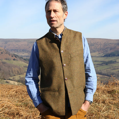 A Stunning patterned tweed Nehru-stle gilet, perfect for the city or country. this finely oven Yorkshire Tweed has a rich orange, green and brown patterning – subtle and very very smart. Handmade in London.