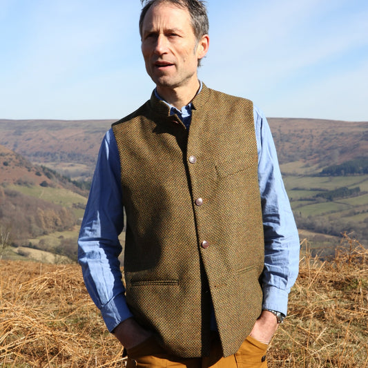 A Stunning patterned tweed Nehru-stle gilet, perfect for the city or country. this finely oven Yorkshire Tweed has a rich orange, green and brown patterning – subtle and very very smart. Handmade in London.