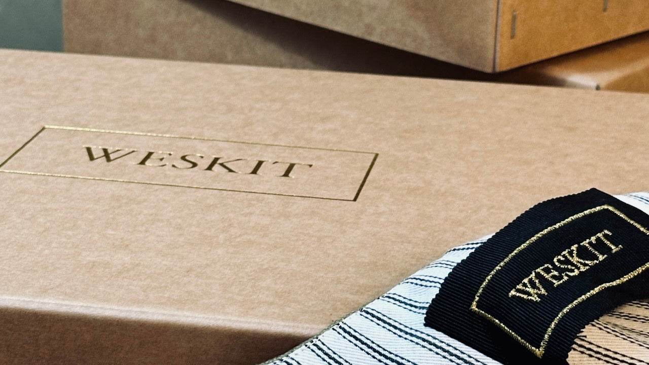 Handmade Stapled Compostable Boxes, Made in London for Weskit. Striped Cotton Ticking Lining and Embroidered Silk Label shown on Weskit Gilet.