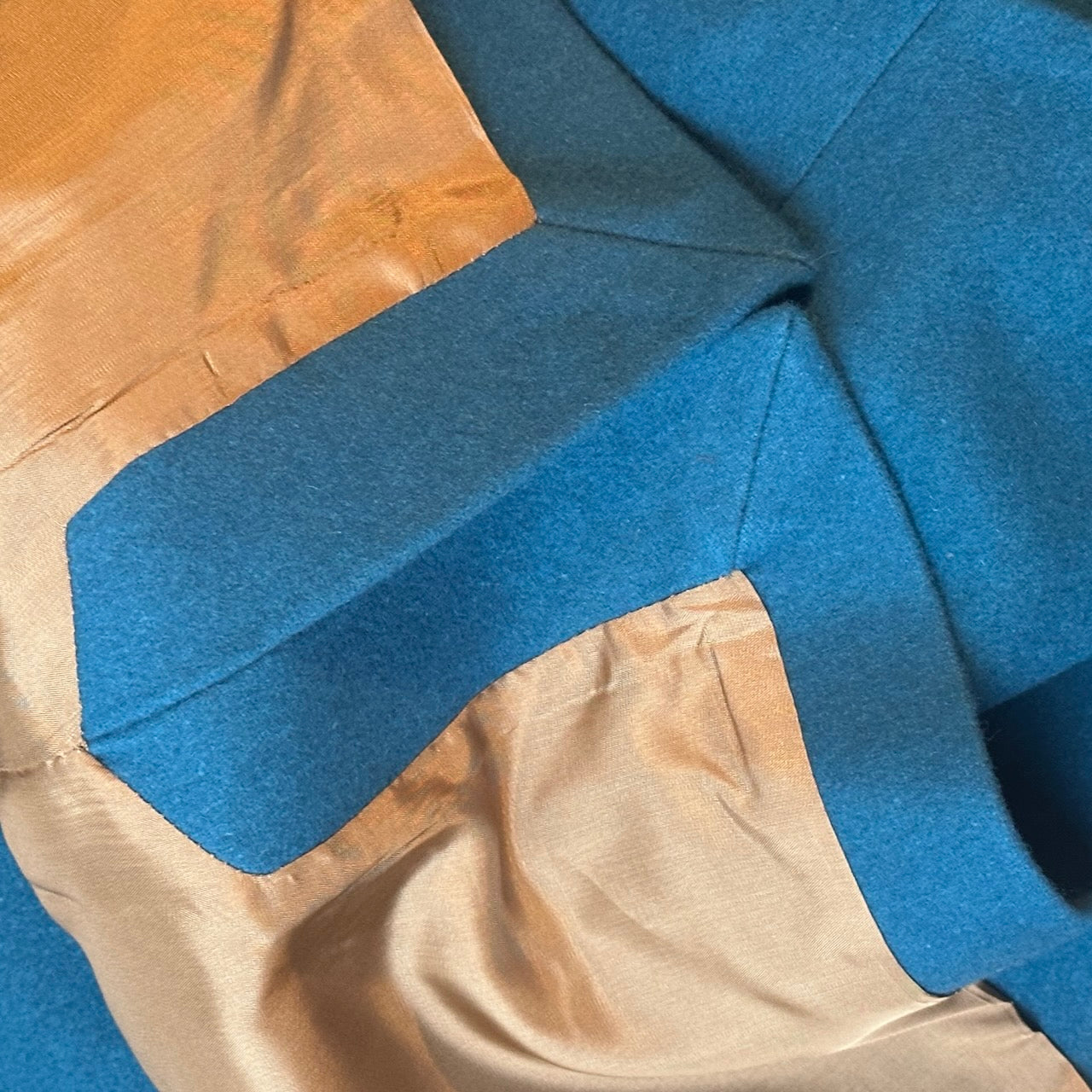 A superb and wonderfully warm alternative to a jacket for autumn winter in a luxurious pure merino wool flannel with a neat cut and ample pocket space. Woven in Yorkshire. Handmade in London. Buttons from Courtney & Co in Gloucestershire. Detail shot showing side vents and lining.