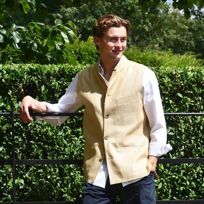 Lighter weight fitted gilet in sandy straw coloured silk weave fabric. Handmade in London this Nehru style gilet boast a Nehru collar, five pockets and is fully lined in pure cotton ticking. Front Butoned Shot.