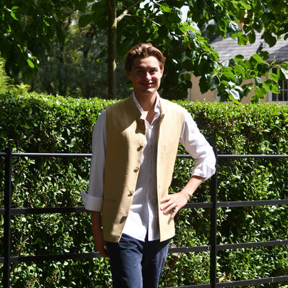 Sand Coloured Silk Matka Gilet. Handmade in London. Photographed in Wales. Shown against Estate Fencing with luscious green backdrop.