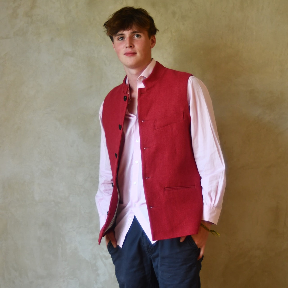 Red Linen Nehru-Style Fitted Waistcoat. Handmade in London. Bespoke and ready to ship. Shown buttoned over a pink shirt.