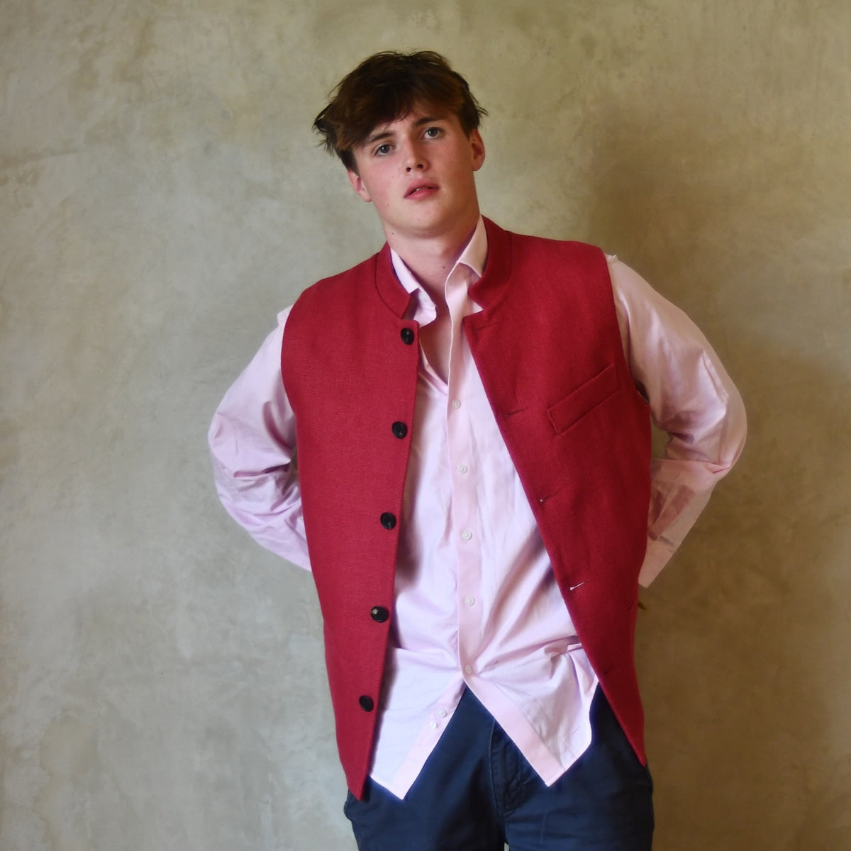 Red Linen Nehru-Style Fitted Waistcoat. Handmade in London. Bespoke and ready to ship. Shown unbuttoned over a pink shirt.