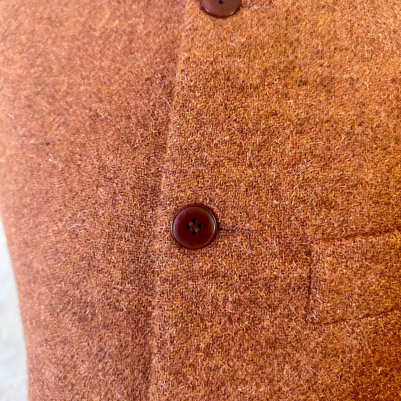 Detail Fabric Shot of  A superb alternative to a jacket or jumper in winter – especially on those cooler days. Warm and superbly smart, this thick wool gilet will work as well inside as outside and has ample pocket space.
This fitted cut has a neat five button-front, tapered darts at the rear and side vents for ease when moving and sitting. Fully lined; Handmade in Britain.