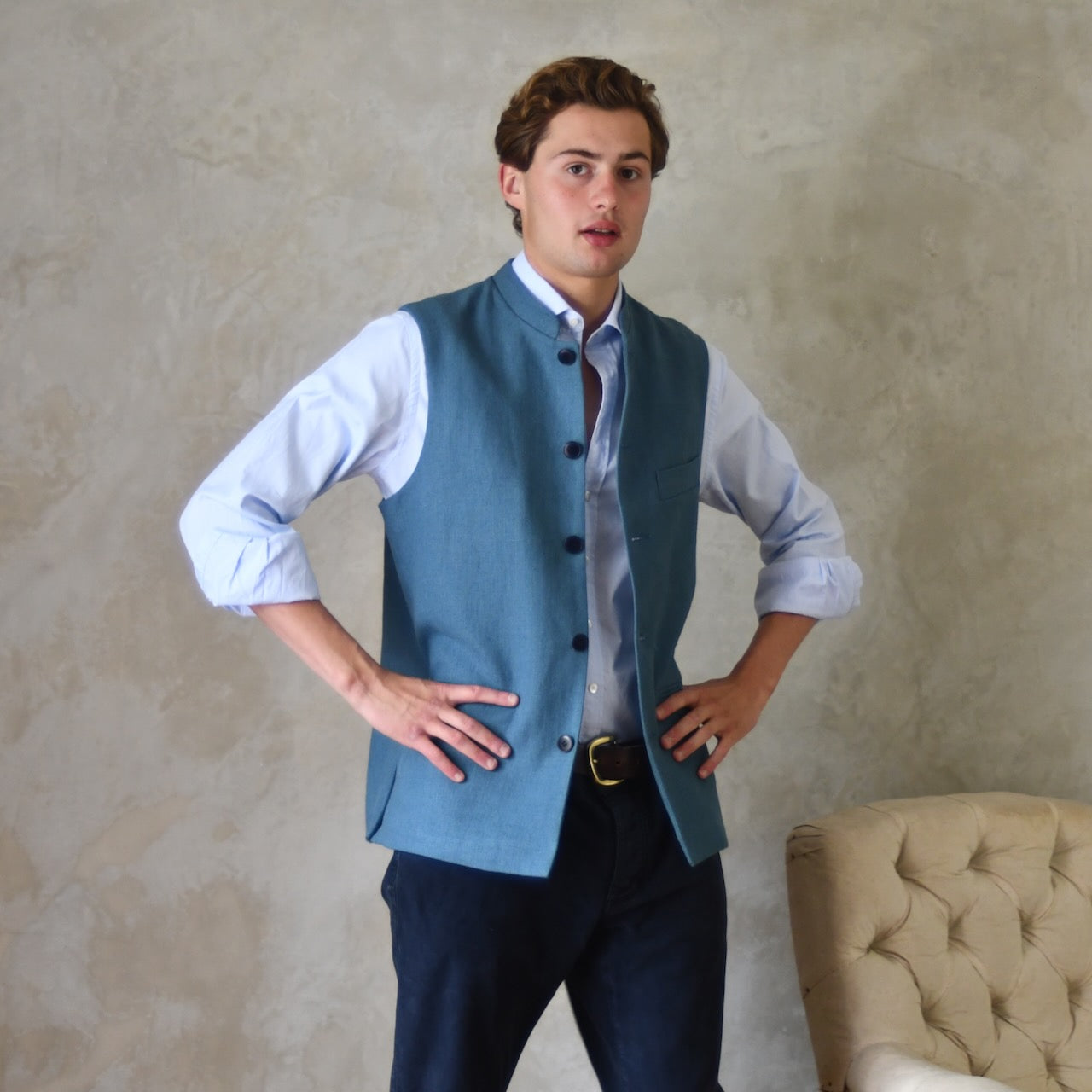 Light blue loose cut linen gilet from Weskit. Handmade in London, this slubby linen waistcoat is made in pure Irish linen and lined in striped cotton ticking. Mandarin collar and Courtney and Co buttons. Entirely made in Great Britain.