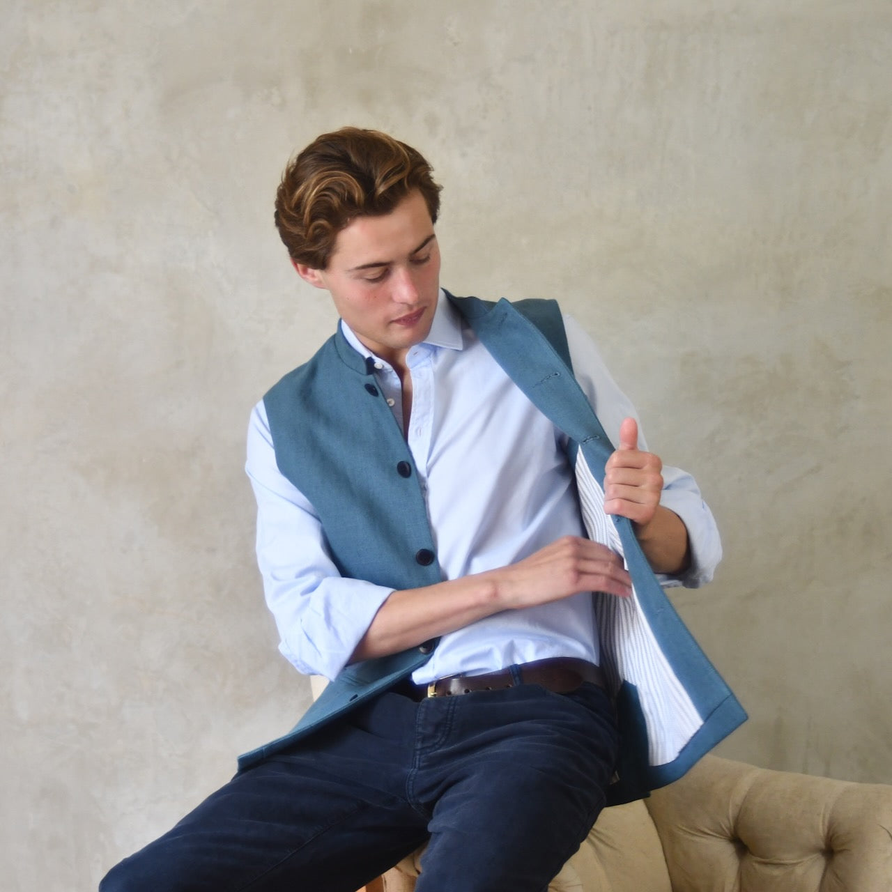 Light blue loose cut linen gilet from Weskit. Handmade in London, this slubby linen waistcoat is made in pure Irish linen and lined in striped cotton ticking. Mandarin collar and Courtney and Co buttons. Entirely made in Great Britain. Lining View.