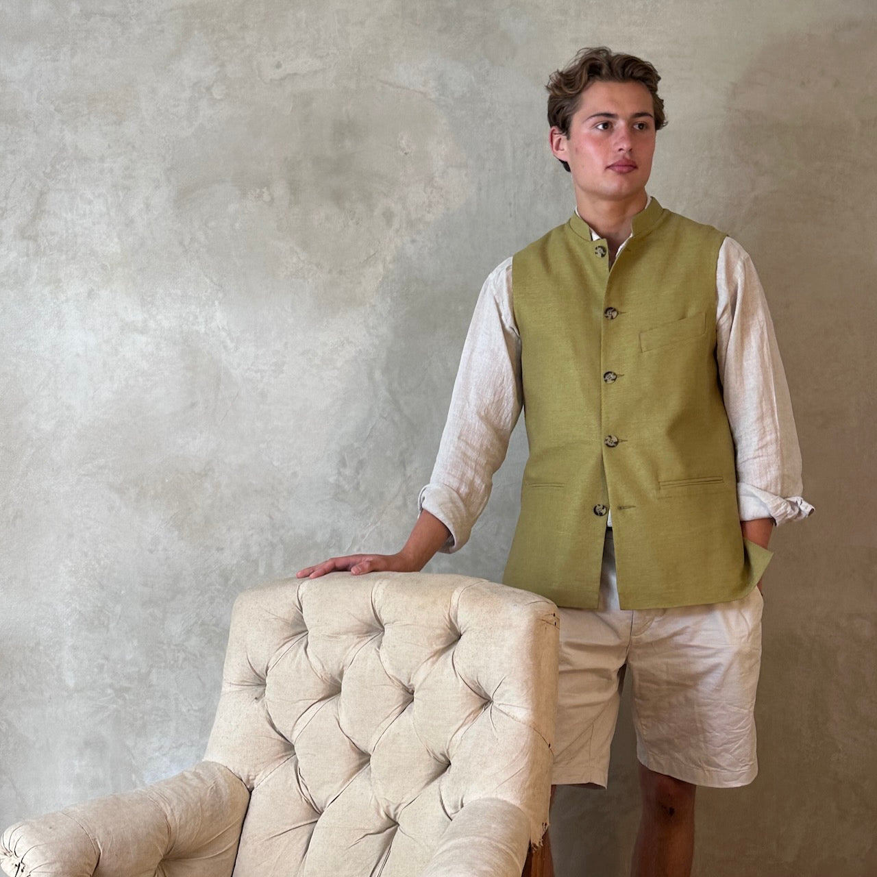 Relaxed fit summer weight gilet in green silk weave. Handmade in London this gilet has a Mandarin collar and is fully lined in pure cotton ticking. Made in Great Britain. Standing shot.