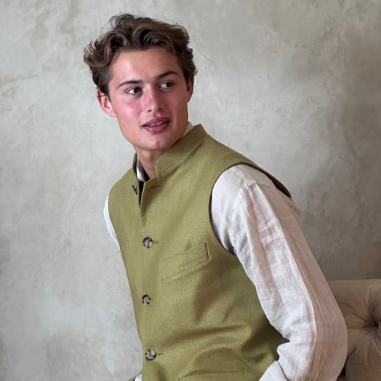 Relaxed fit summer weight gilet in green silk weave. Handmade in London this gilet has a Mandarin collar and is fully lined in pure cotton ticking. Made in Great Britain. Close up shot.