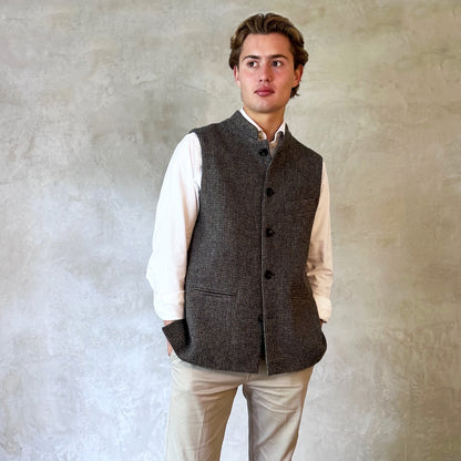 Warm Nehru Style Gilet in pure wool tweed from Hawick. Handmade in London this waistcoat has a gentle patterning in blue and shades of taupe and grey. Ample pocket space, side vents and a nead Mandarin Collar. Perfect for Winter wear.