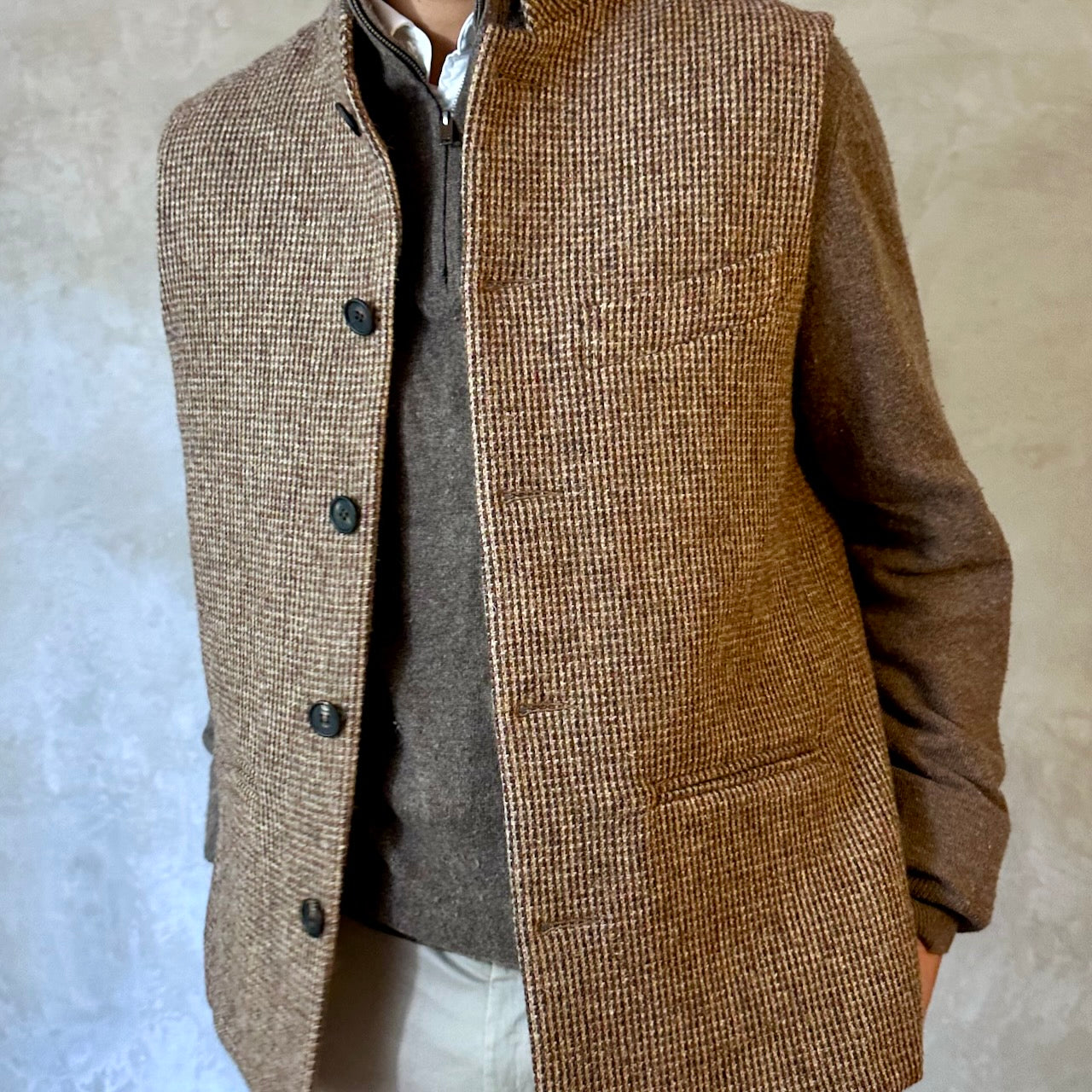 A wonderfully warm Nehru-style gilet in a thick tweed from Hawick. Designed in Wales, oven in England, handmade in London with buttons from Gloucestershire, this is a truly British Waistcoat. Detail Shot.