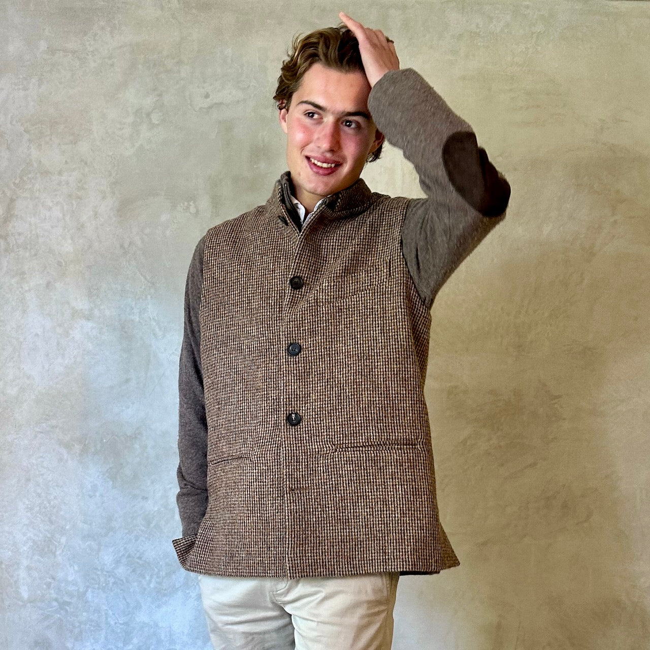 A wonderfully warm Nehru-style gilet in a thick tweed from Hawick. Designed in Wales, oven in England, handmade in London with buttons from Gloucestershire, this is a truly British Waistcoat. Detail Shot.