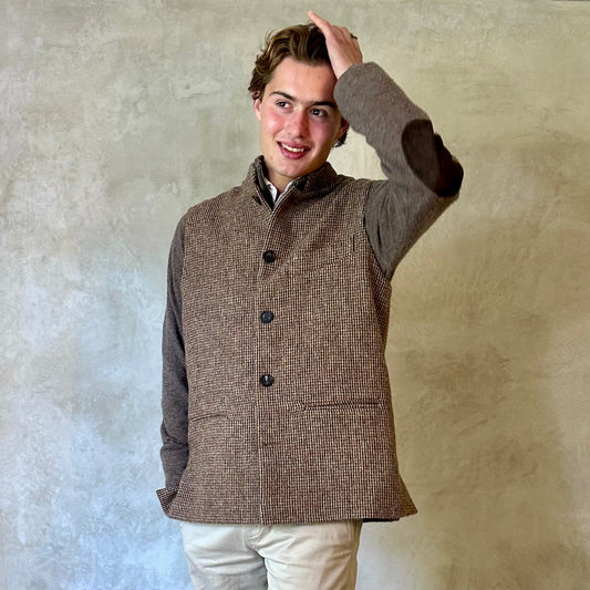 A wonderfully warm Nehru-style gilet in a thick tweed from Hawick. Designed in Wales, oven in England, handmade in London with buttons from Gloucestershire, this is a truly British Waistcoat. Detail Shot.