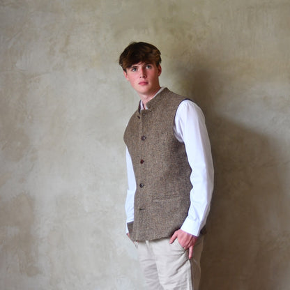 Buttoned Side View of Bespoke Nehru Style Gilet in Brown Patterned Pure Wool Tweed. This tweed from Lovat Mill has a delicate patterning. Shown over a white shirt with Chinos.