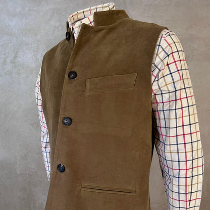 Slim Cut Nehru Style Gilet in Khaki Moleskin. This pure cotton gilet is lined in striped cotton Ticking. With a Nehru collar and five pockets it will take you everywhere and keep you warm on cooler days. Made by Hand in London. Shown buttoned over check country style shirt.