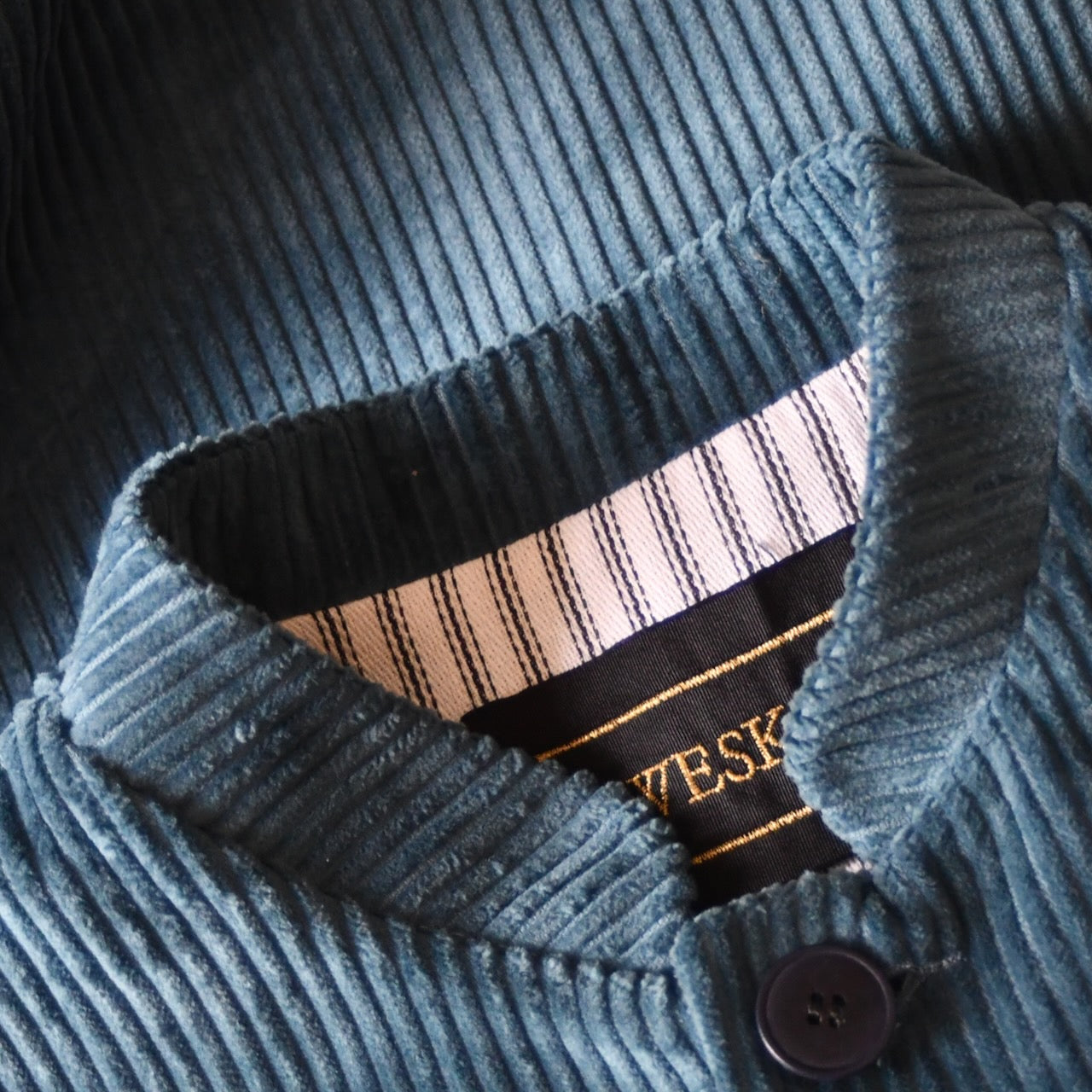 Detail Collar shot of Loose Fit Nehru Style Gilet in Teal Corduroy. This Bespoke pure cotton corduroy waistcoat is handmade in London. Shot shows mandarin collar on Weskit waistcoat.