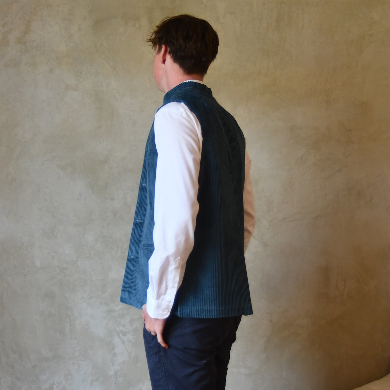 Side Rear View of Slim Cut Gilet in Teal Coloured Pure Cotton Corduroy. Handmade in London this Bespoke waistcoat can be ordered with a range of linings and collar types.